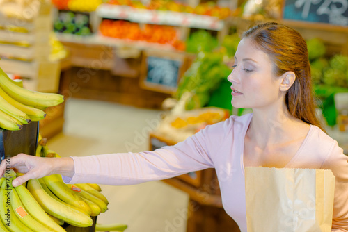 Lady buying bananas