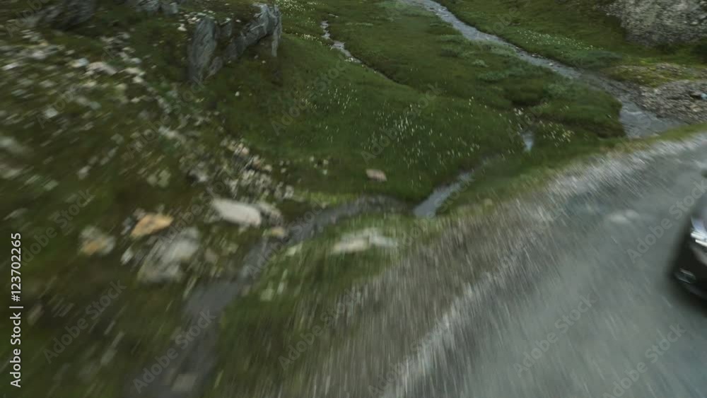 Aerial Shot of Car Moving on Curvy Mountain Road in Norway. Aerial Shot of Car Moving on Curvy Mountain Road in Norway.