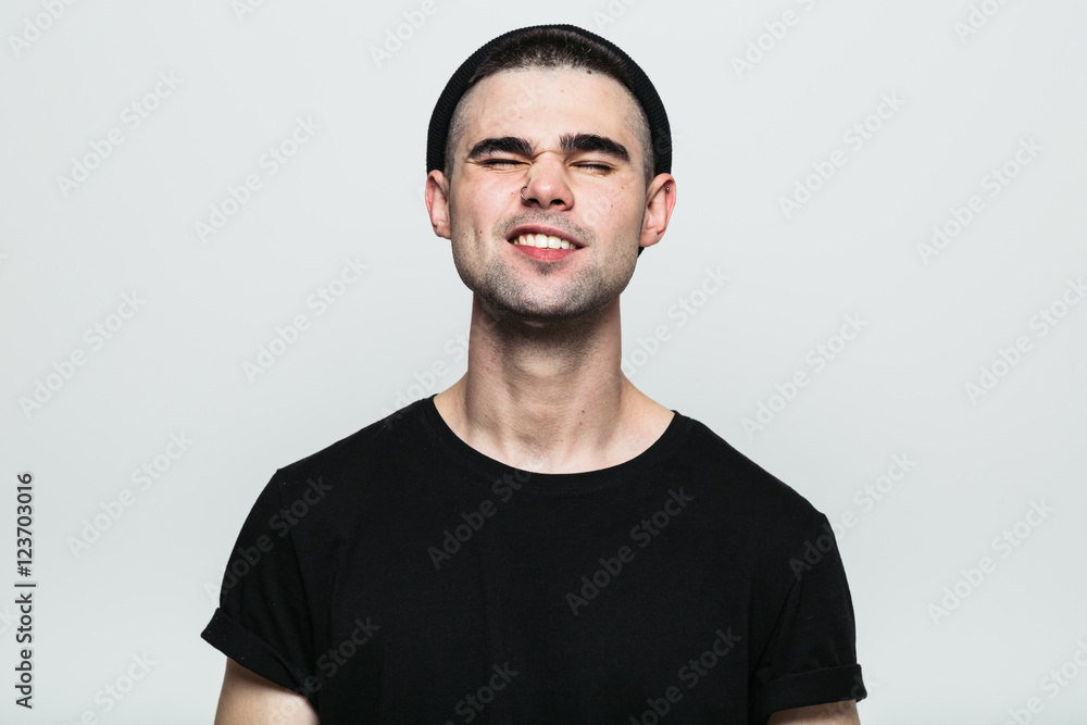 Studio portrait of adult man in hat feeling pain with his eyes closed on white background. Studio portrait of adult man in hat feeling pain with his eyes closed on white background.
