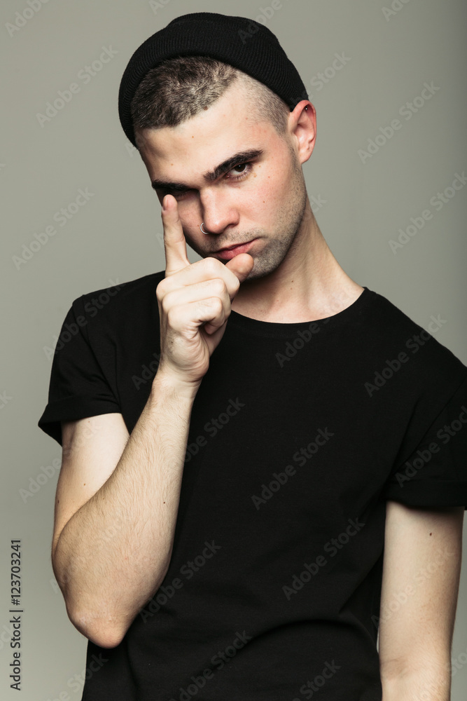 Man on gray studio background shaking finger Man on gray studio background shaking finger