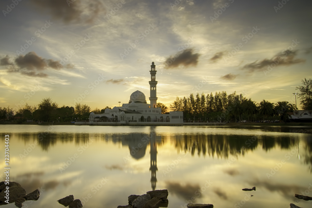 dark and soft image of beautiful mosque and reflection on the lake during sunset sunrise