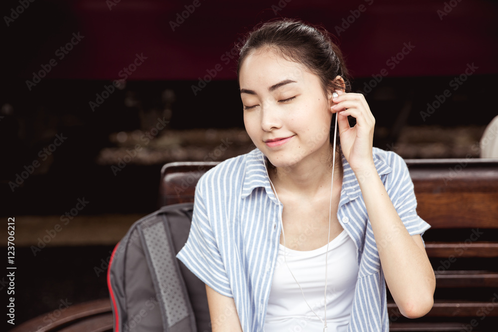 Fototapeta premium Young asian lady listen to music