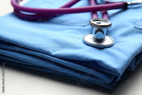 Doctor coat with stethoscope on the desk