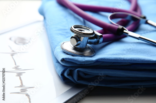 Doctor coat with stethoscope on the desk