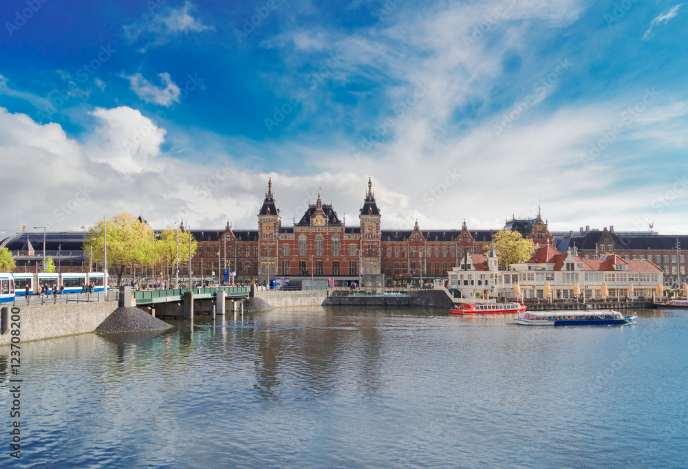 Fototapeta premium cityscape with central railway station and old town canal, Amsterdam, Holland