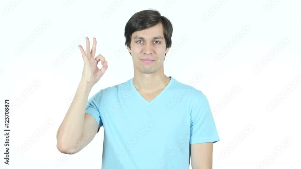 Okay Sign by Confident Young Casual Man, White Background Okay Sign by Confident Young Casual Man, White Background