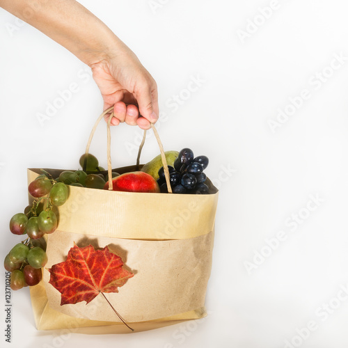 Hand picks package with fresh fruit