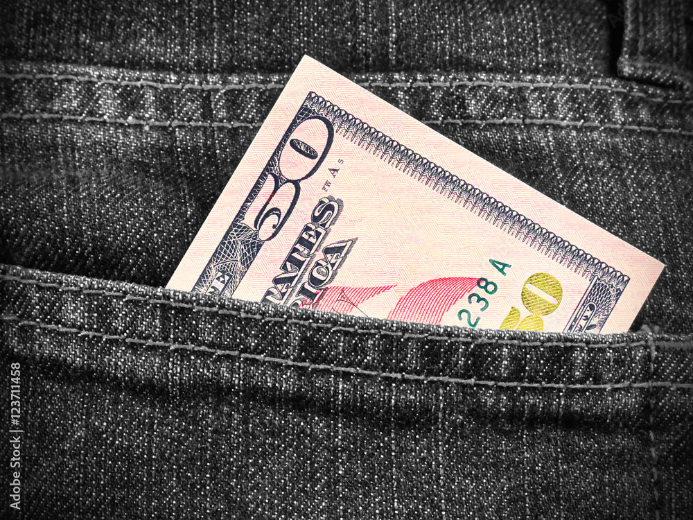 Obraz premium Fifty dollars in jeans pocket