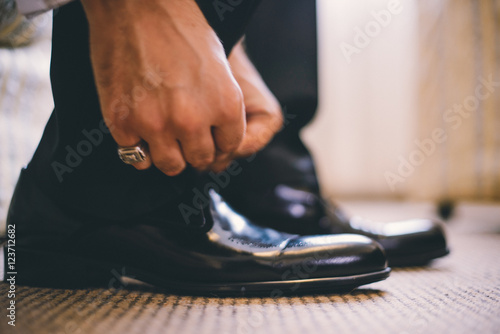 Man ties up his shoes