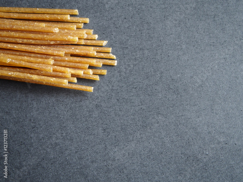 Wholegrain pasta on black background