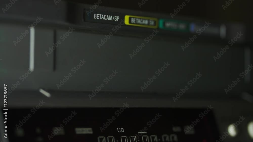 Hand Pushing The Eject Button And Video Cassette Coming Out Of A BetaMax Hand Pushing The Eject Button And Video Cassette Coming Out Of A BetaMax