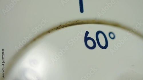 Man Fingers Setting The Temperature On An Old Washing Machine