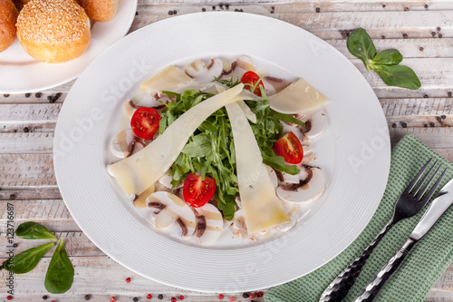 Arugula salad with mushrooms and cheese photo