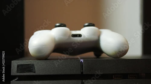 Hand Putting Down Gaming Controller And Ejecting The Disc From Console