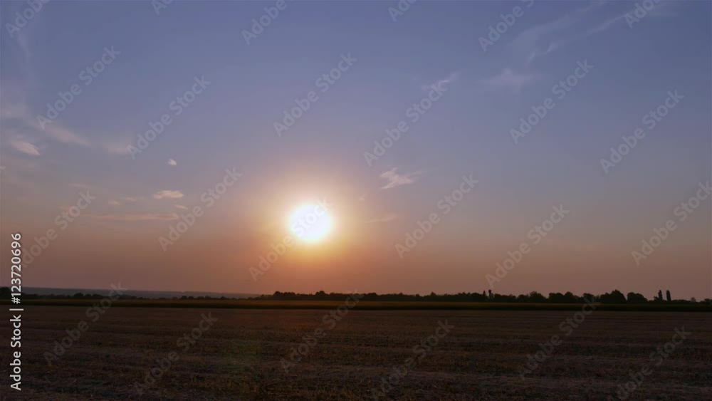 Sunset twilight in rural field landscape 4k time-lapse video. Sun moving in clear sky, evening countryside nature Sunset twilight in rural field landscape 4k time-lapse video. Sun moving in clear sky, evening countryside nature
