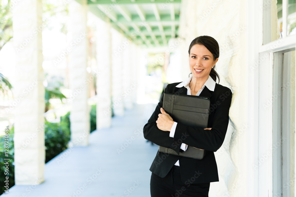 Attractive female woman real estate agent businesswoman on house veranda Attractive female woman real estate agent businesswoman on house veranda