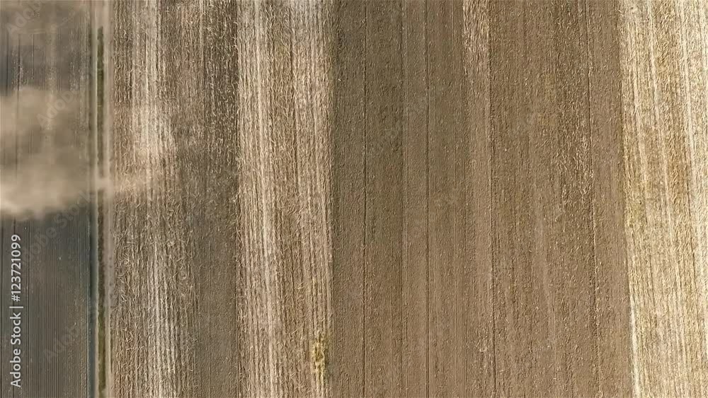 Cultivation soil: farm tractor plowing on cropped field after harvesting HD video aerial top view. Agricultural machine equipment. Preparation for sowing seed Cultivation soil: farm tractor plowing on cropped field after harvesting HD video aerial top view. Agricultural machine equipment. Preparation for sowing seed
