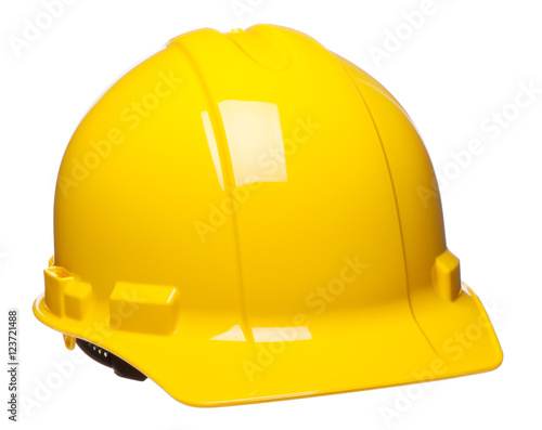 Yellow construction safety hard hat helmet at slight angle isolated on white background for use alone or as a design element photo
