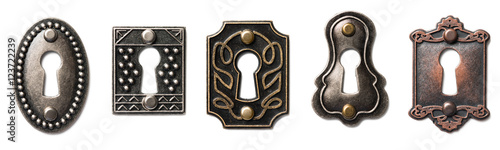 Five patined bronze and brass decorative antique keyholes Isolated on White Background photo