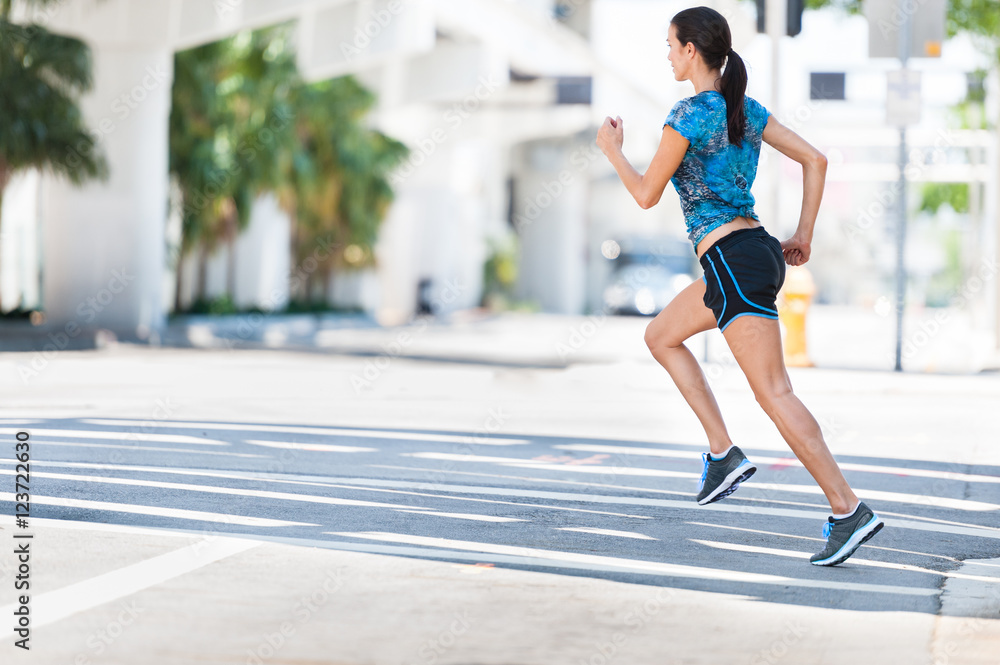Young woman running jogging on downtown street Young woman running jogging on downtown street