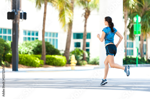 Young woman running jogging on downtown street