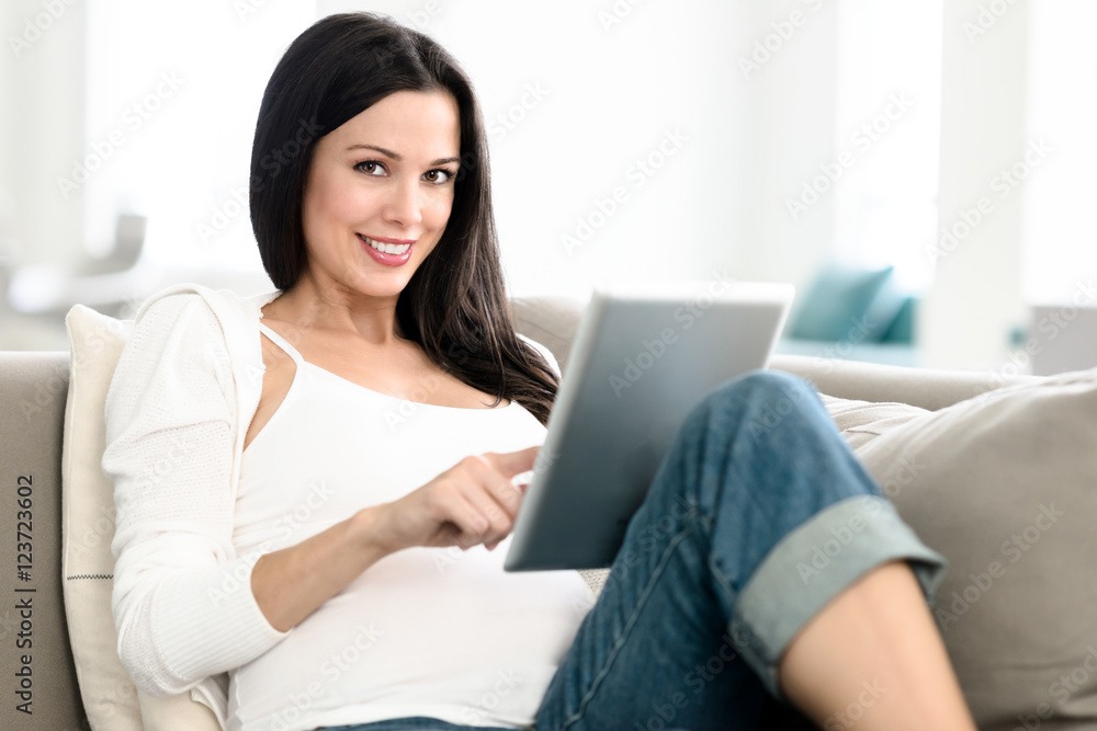 Pregnant Woman Lounging with Digital Tablet Pregnant Woman Lounging with Digital Tablet