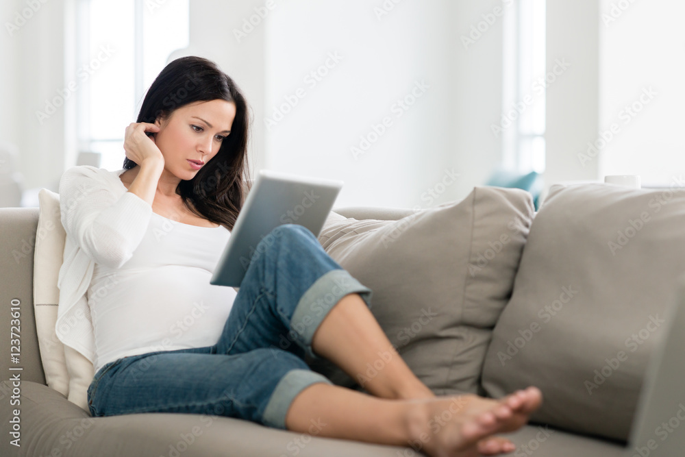 Pregnant Woman Lounging with Digital Tablet Pregnant Woman Lounging with Digital Tablet