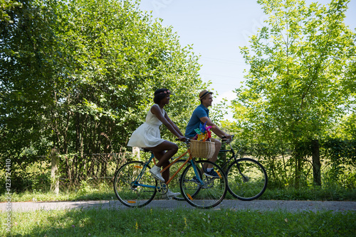 Young multiethnic couple having a bike ride in nature