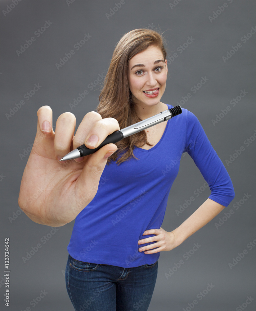 playful beautiful young woman giving pen for signature of contract