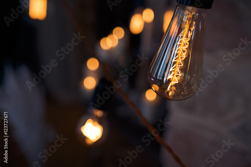 Electricity sparkles in the bulb put in a garland