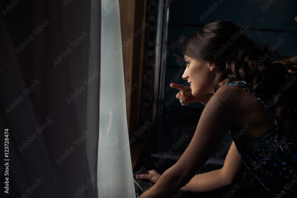 Brunette lady looks interesting through the window Brunette lady looks interesting through the window