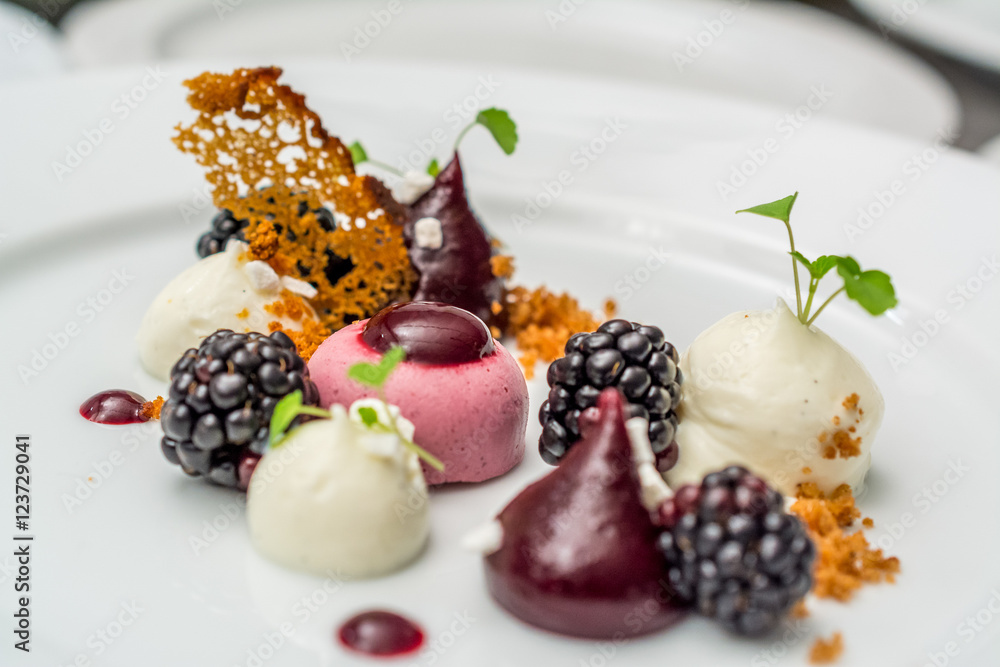 Michelin star dessert with raspberry sweets, cookie crumble