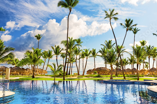 Fototapeta Naklejka Na Ścianę i Meble -  Tropical beach resort with umbrellas and lounge chairs