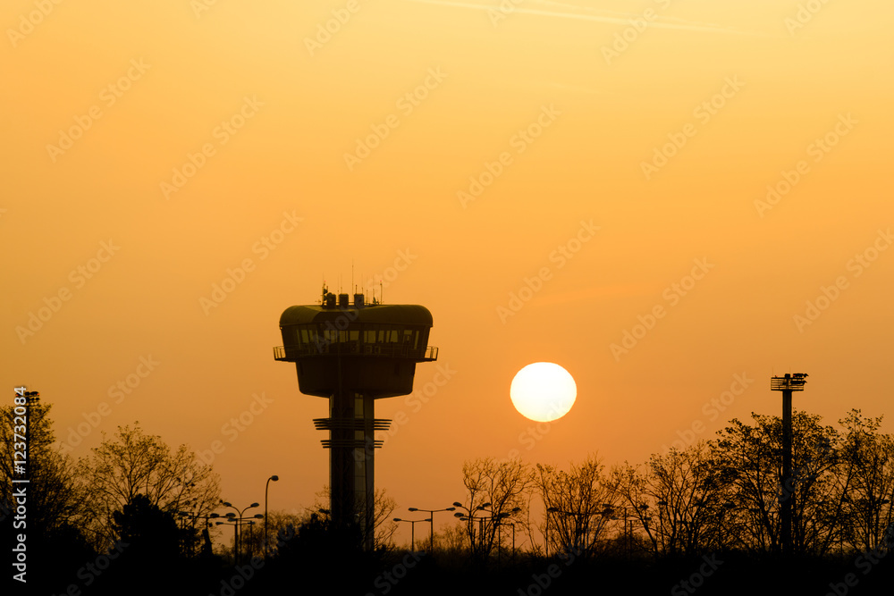 Airport control tower silhouette at sunrise Airport control tower silhouette at sunrise