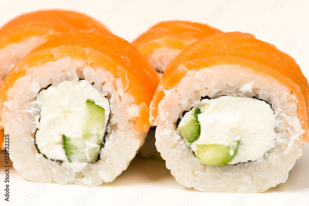 two sushi rolls with salmon closeup