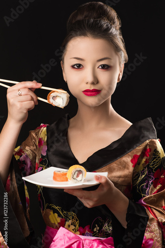 charming Korean girl with dish sushi rolls