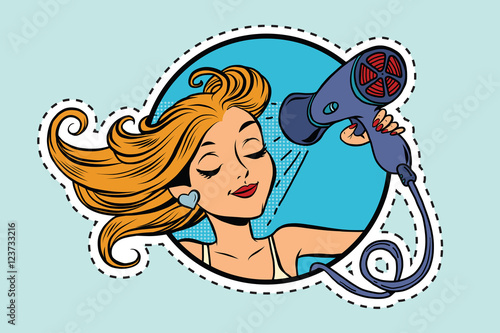 Beautiful girl drying her hair with Hairdryer