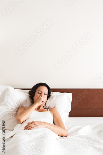 Sick Woman Coughing in Bed © Eric Hood