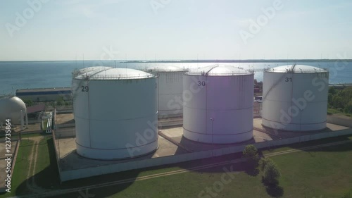 Aerial shot of Storage Tank near Harbour. Blue Sea on Background.