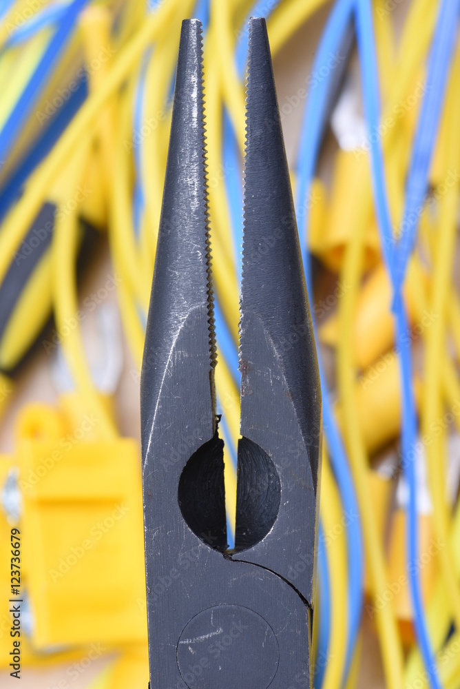 Close up electrical pliers and cables