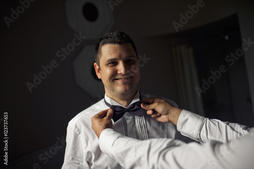 Happy groom with the purple bow-tie
