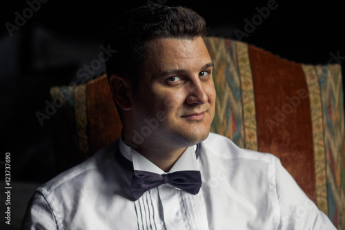 Portrait of the handsome groom with the bow-tie