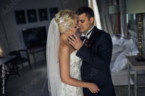 Emotional newlyweds in the sophisticated hotel room