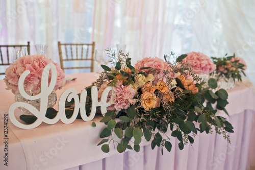 Fototapeta Naklejka Na Ścianę i Meble -  The vases of flowers stand on the wedding table