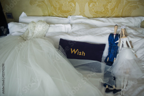 wedding dress lying on the bed with other things © nastasenko