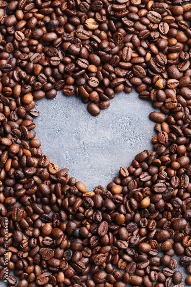 Roasted coffee beans on a grey table Roasted coffee beans on a grey table
