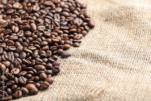 Brown roasted coffee beans on sackcloth