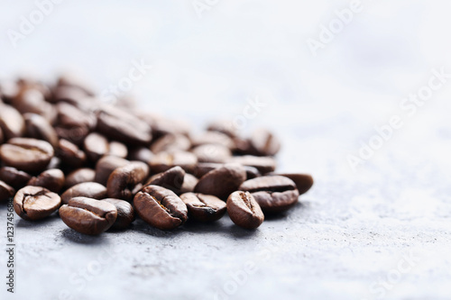 Roasted coffee beans on a grey table
