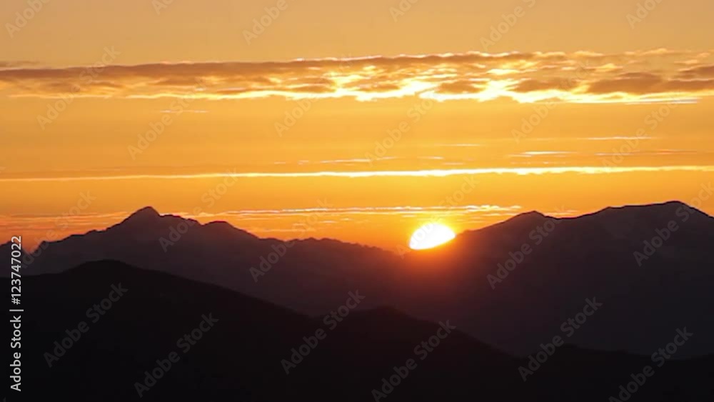 Amazing colorful sunset mountain chain. Time lapse sky background. Beautiful fiery sunset wide angle lens Amazing colorful sunset mountain chain. Time lapse sky background. Beautiful fiery sunset wide angle lens