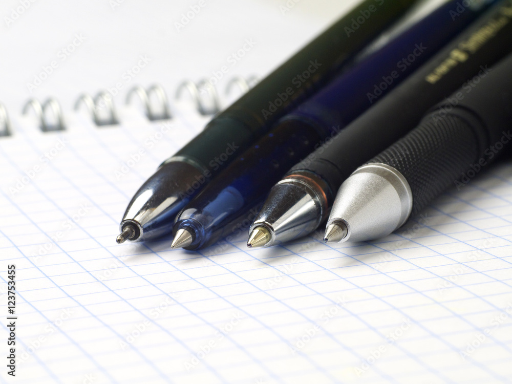 set of ballpoint pen on open spiral notebook, macro, shallow depth of field set of ballpoint pen on open spiral notebook, macro, shallow depth of field